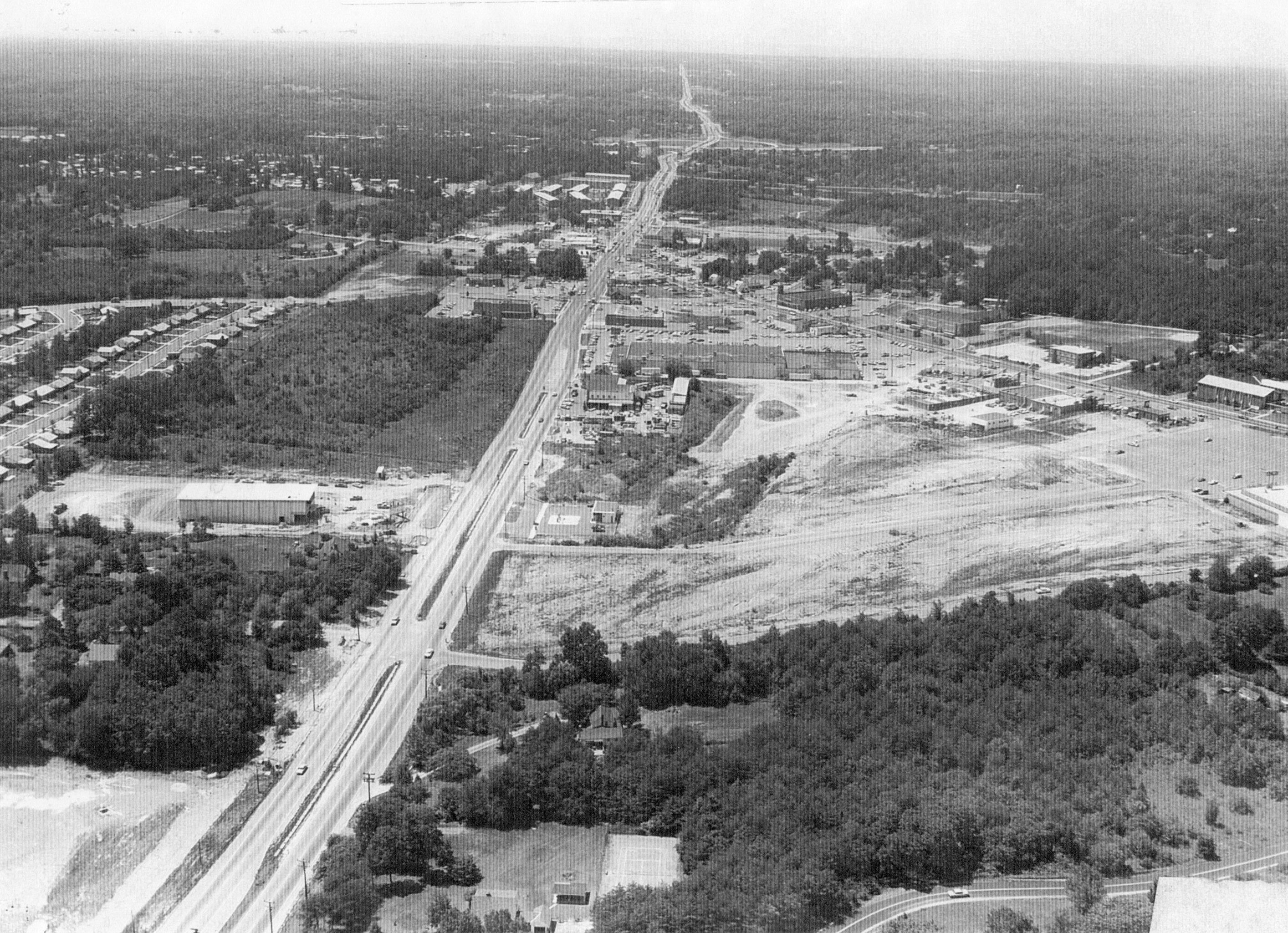 View of Little River Turnpike looking west from Evergreen Lane toward the Beltway.  Large undeveloped space to the right will become home to K-mart in 1972.  Photograph is courtesy of the photographic archive of the Annandale Chamber of Commerce. toward the Beltway.  Large undeveloped space to the right will become home to K-mart in 1972.